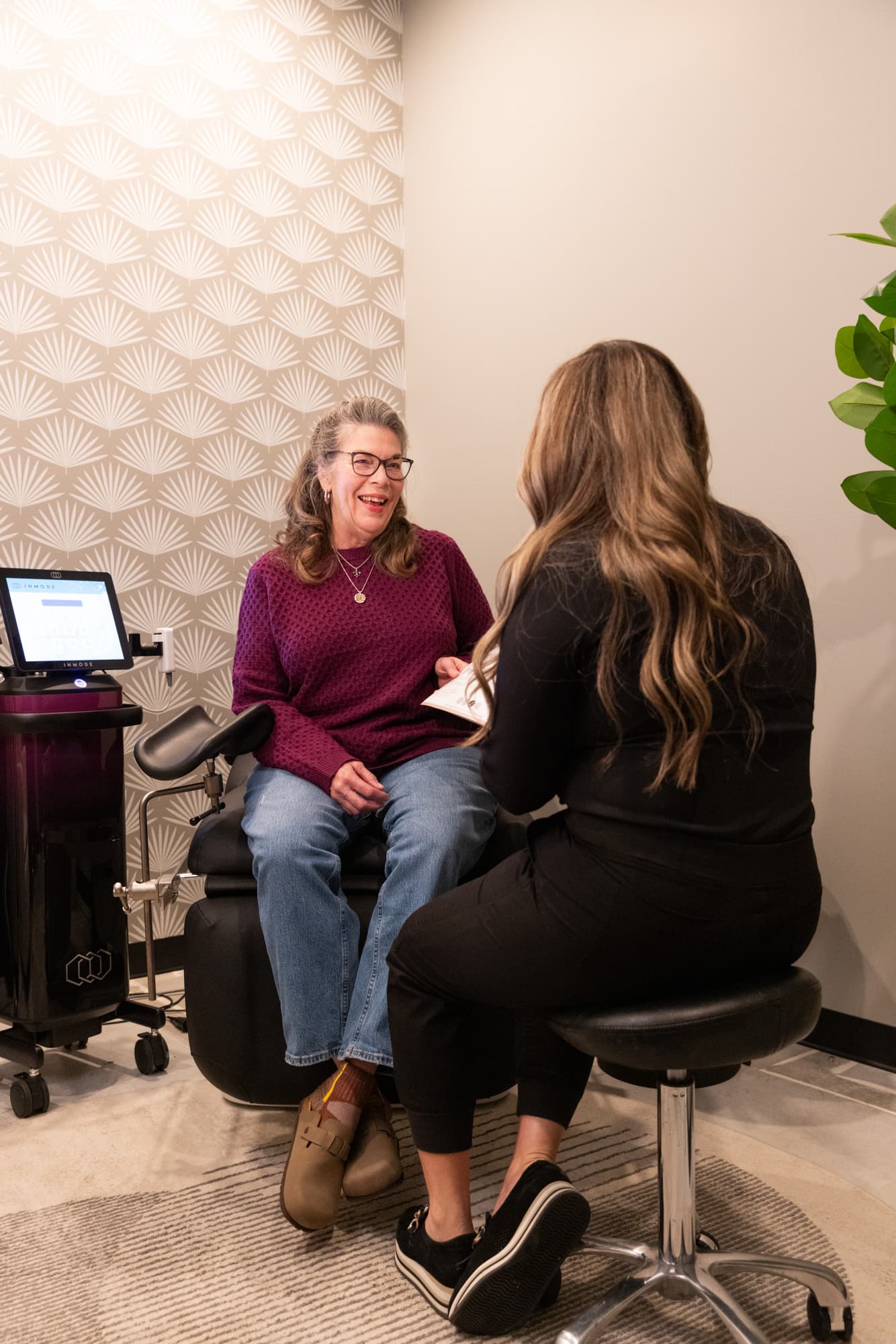 A consultation at The Sonography Studio, with a clinician talking through options beside the treatment chair